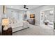 Light-filled primary bedroom with a ceiling fan, sitting chair and connected sitting room at 2721 Kilgo Way, Charlotte, NC 28205