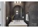 Stylish powder room with white countertop, decorative vase and arched mirror at 2721 Kilgo Way, Charlotte, NC 28205