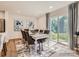 Elegant dining room showcasing a large table, stylish chairs, contemporary lighting, and a sliding glass door at 2949 Legacy Ridge Ln, Catawba, NC 28609