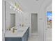 Well-lit bathroom with double sinks, modern fixtures, and a separate glass-enclosed shower at 315 Arlington Ave # 1206, Charlotte, NC 28203