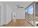 Bright room showcases wood flooring, an expansive window with cityscape views, and a modern ceiling fan at 315 Arlington Ave # 1206, Charlotte, NC 28203