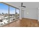 Bright bedroom with hardwood floors, ceiling fan, and a large window with a city view at 315 Arlington Ave # 1206, Charlotte, NC 28203
