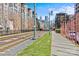 View of LYNX light rail along landscaped pathway at 315 Arlington Ave # 1206, Charlotte, NC 28203