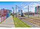 View of the LYNX Blue Line light rail near landscaped green space and colorful art installation at 315 Arlington Ave # 1206, Charlotte, NC 28203