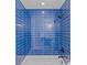Close-up of a modern shower with sleek blue tiles and black fixtures at 315 Arlington Ave # 1206, Charlotte, NC 28203