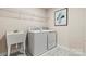 Laundry room with washer, dryer, utility sink, and wire shelving at 318 Balboa St, Matthews, NC 28104
