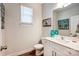 Half bathroom with white cabinet, modern faucet, and wood look floors at 3925 Rothwood Ln, Harrisburg, NC 28075
