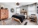 Chic bedroom with a wooden bed frame, patterned rug, and stylish decor at 3925 Rothwood Ln, Harrisburg, NC 28075