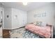 Bright bedroom with a daybed, white closet doors, and a blue floral area rug at 3925 Rothwood Ln, Harrisburg, NC 28075