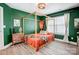 Stylish bedroom with green walls, wood bed frame, and modern decor at 3925 Rothwood Ln, Harrisburg, NC 28075