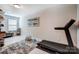 Spacious bonus room featuring modern marble floors, a treadmill, and a stylish cat tower at 3925 Rothwood Ln, Harrisburg, NC 28075