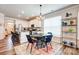Bright dining area adjacent to a modern kitchen, featuring sleek countertops and stainless steel appliances at 3925 Rothwood Ln, Harrisburg, NC 28075