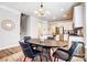 Dining room with stylish lighting fixture conveniently located next to a modern kitchen at 3925 Rothwood Ln, Harrisburg, NC 28075