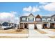 Attractive townhome with a two-car garage and a landscaped front yard situated in a residential neighborhood at 3925 Rothwood Ln, Harrisburg, NC 28075