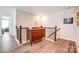 Upstairs hallway with wood floors, staircase, and decorative accents at 3925 Rothwood Ln, Harrisburg, NC 28075