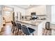Well-appointed kitchen with stainless steel appliances, white cabinets, and a spacious island with barstool seating at 3925 Rothwood Ln, Harrisburg, NC 28075