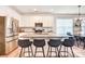 Contemporary kitchen featuring a large island with seating, stainless steel appliances, and white cabinetry at 3925 Rothwood Ln, Harrisburg, NC 28075