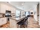 Modern kitchen with stainless steel appliances, granite countertops, and an open layout to the living area at 3925 Rothwood Ln, Harrisburg, NC 28075