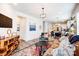 Inviting living room showcasing open layout, stylish furnishings, and access to the kitchen and dining area at 3925 Rothwood Ln, Harrisburg, NC 28075