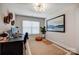 Office area with a large window, desk, and decorative accessories at 3925 Rothwood Ln, Harrisburg, NC 28075