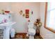 Cozy half bathroom featuring a pedestal sink, toilet, and decorative wall art at 4009 Polkville Rd, Shelby, NC 28150