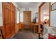 Inviting entryway with wood paneling, bench seating, and view into office space creating a welcoming ambiance at 4009 Polkville Rd, Shelby, NC 28150