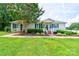 Charming single-story home featuring a well-maintained lawn, inviting front porch, and accessible ramp at 4009 Polkville Rd, Shelby, NC 28150
