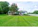 Charming single-story home with lush front lawn, landscaped garden and handicap access at 4009 Polkville Rd, Shelby, NC 28150