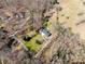 A bird's-eye view of the property showing the house and the surrounding wooded area at 534 Kirby Ln, Matthews, NC 28104