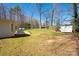 Expansive backyard featuring a playhouse, ample grassy space, and perimeter trees providing privacy at 534 Kirby Ln, Matthews, NC 28104