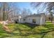 View of the backyard of the house, featuring patio, landscaping, and ample space at 534 Kirby Ln, Matthews, NC 28104