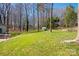 Spacious backyard with lush lawn and mature trees, perfect for outdoor activities and relaxation at 534 Kirby Ln, Matthews, NC 28104