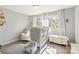 Bright bedroom features a window, area rug, crib, and furniture at 534 Kirby Ln, Matthews, NC 28104