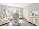 Bright bedroom features a window, area rug, crib, and furniture at 534 Kirby Ln, Matthews, NC 28104