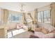 Bright bedroom features a window, area rug, crib, and chairs at 534 Kirby Ln, Matthews, NC 28104