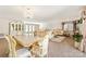 Open-concept living room and dining room with hardwood floors and elegant furnishings at 534 Kirby Ln, Matthews, NC 28104