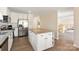 Open kitchen with a center island, stainless steel appliances, and hardwood floors at 534 Kirby Ln, Matthews, NC 28104
