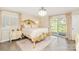 Bright main bedroom features hardwood floors, sliding glass door, and ornate bed frame at 534 Kirby Ln, Matthews, NC 28104