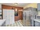 Kitchen with stainless steel refrigerator, brick wall, and white cabinetry at 5485 S Nc 16 Hwy, Maiden, NC 28650