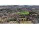 Scenic aerial view showing expansive land with tree cover and a distant home, providing privacy at 5534 Little Mountain Rd, Catawba, NC 28609