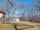 View of the backyard with a small shed, neutral siding, and blue steel roof at 5534 Little Mountain Rd, Catawba, NC 28609