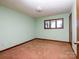 Cozy bedroom with neutral carpeting, a window, and a classic light fixture at 5534 Little Mountain Rd, Catawba, NC 28609