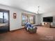 Bright living room featuring large windows, a vintage clock, and cozy seating area at 5534 Little Mountain Rd, Catawba, NC 28609
