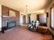 Cozy living room with brick fireplace and a comfortable armchair, great for relaxation at 5534 Little Mountain Rd, Catawba, NC 28609
