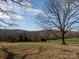 Lush, expansive yard framed by trees and hillsides beneath a partly cloudy sky at 5534 Little Mountain Rd, Catawba, NC 28609