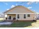 Exterior view of back yard with covered patio, sliding glass doors, and partially fenced yard at 571 Rough Hewn Ln, Rock Hill, SC 29730