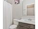 Well-lit bathroom featuring a shower with a curtain and a modern sink and vanity at 571 Rough Hewn Ln, Rock Hill, SC 29730