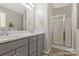Modern bathroom featuring a double sink vanity, a stand-up shower, and updated fixtures at 571 Rough Hewn Ln, Rock Hill, SC 29730