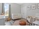 This cozy bedroom has wood floors, an area rug, and ample natural light through its window at 571 Rough Hewn Ln, Rock Hill, SC 29730