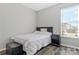 This bedroom is well lit, and features a wooden floor and a stylish nightstand at 571 Rough Hewn Ln, Rock Hill, SC 29730